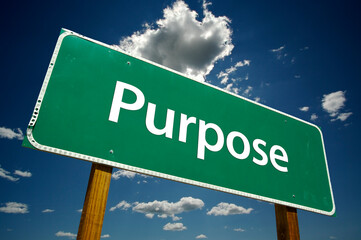 Purpose Green Road Sign On Cloudy Blue Sky Background