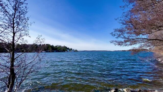 Video clip over a blue lake during spring. Nice calm Swedish nature. Sunny day. M&auml;laren, Stockholm, Sweden.
