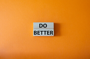 Do better symbol. Wooden blocks with words Do better. Beautiful orange background. Business and Do better concept. Copy space.