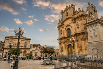 THe beautiful Busacca Square in Scicli with monument and church
