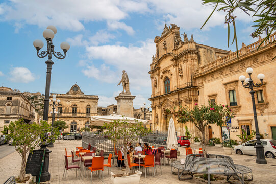THe beautiful Busacca Square in Scicli with monument and church
