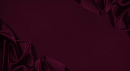 Black red burgundy silk satin. Soft wavy folds. Shiny fabric. Dark cherry luxury background with...