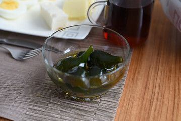 Fig jam in glass on an old wooden table with space for text.