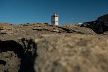 Rock view in selective focus with the Lighthouse of Cape Carvoeiro in the background. Peniche, Portugal, Europe.
