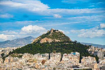 Lycabettus Hill under white clouds seen from Acropolis