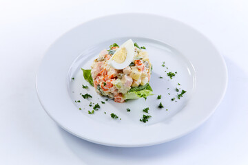 traditional russian salad on white plate