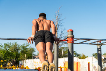 Fototapeta premium sportswoman doing outdoor gymnastics, athlete, calisthenics
