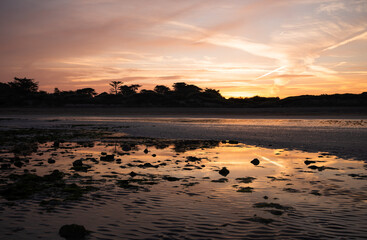 Naklejka premium Sunrise over the beach at Daymer Bay, Cornwall UK