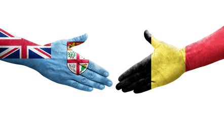 Handshake between Belgium and Fiji flags painted on hands, isolated transparent image.