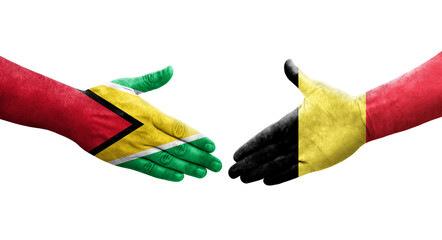 Handshake between Belgium and Guyana flags painted on hands, isolated transparent image.