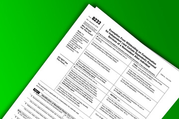 Obraz premium Form 8233 documentation published IRS USA 43443. American tax document on colored