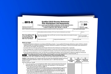 Fototapeta premium Form 8915-D documentation published IRS USA 44199. American tax document on colored
