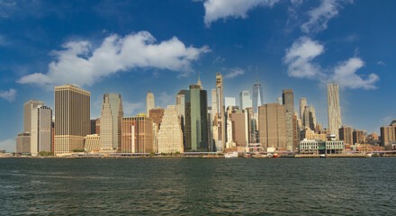 White clouds over lower manhattan panorama from brooklyn
