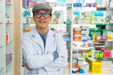 Portrait of Handsome Asian man professional pharmacist ready for medication advice about health, medicine, drugs and supplements in modern drugstore. Medical pharmacy and healthcare providers concept.