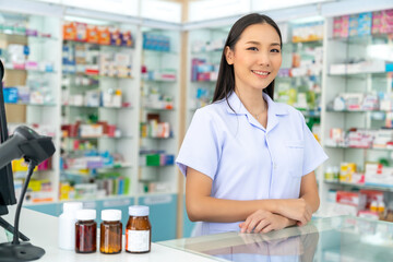 Portrait of Attractive Asian woman professional pharmacist ready for medication advice about medicine, drugs and supplements in modern drugstore. Medical pharmacy and healthcare providers concept.