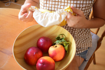 A woman hand putting a cloth on a pot to cover taste