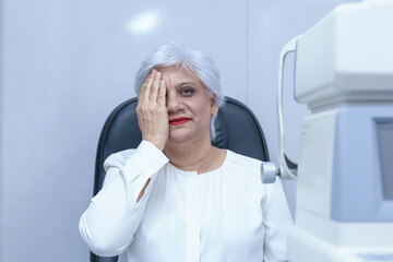 Indian woman close one eye by hand for eye testing, as having reading vision problem with space for text.