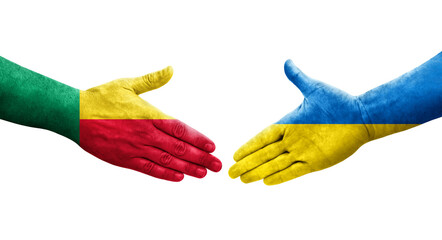 Handshake between Benin and Ukraine flags painted on hands, isolated transparent image.