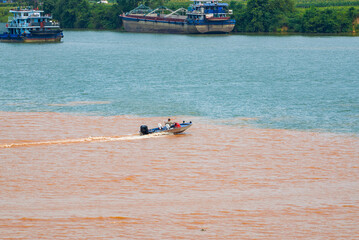 A sailor drives a speedboat at the confluence of two rivers