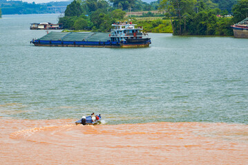 A sailor drives a speedboat at the confluence of two rivers
