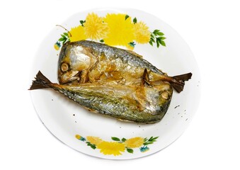 Two grilled mackerel in a white plate