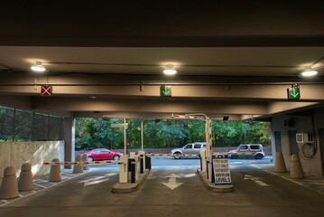 Interior of a parking lot in a building with three gates.