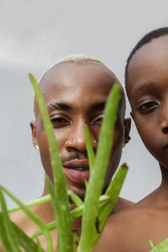 Close up of father and son's face with aloe vera