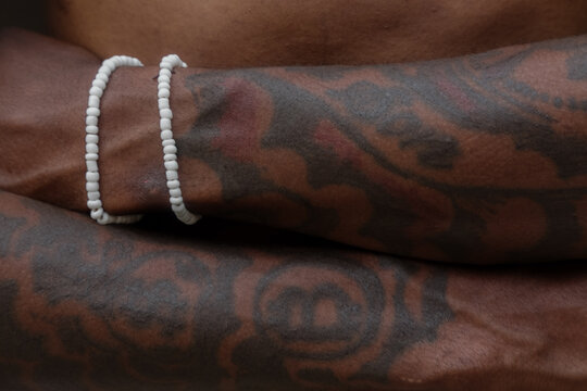 Folded tattooed arms