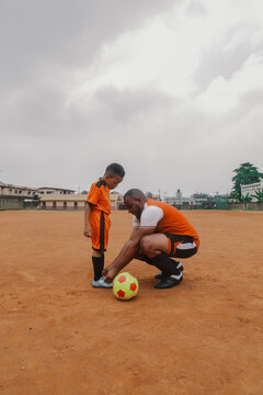 Son watches father as he ties shoelace