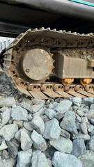 excavator on gravel stones at a construction project site