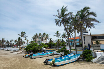 Fototapeta na wymiar A boat sits on a beach at Boca Del Rio, Veracruz, Mexico.