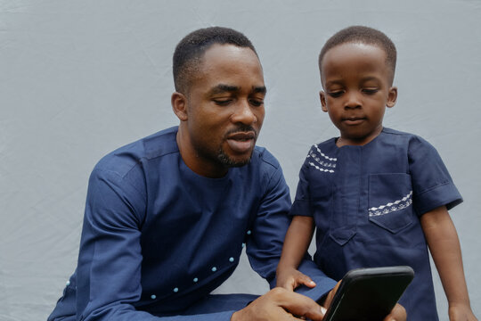 Father and son observing the phone