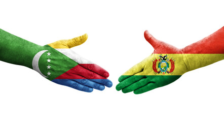 Handshake between Bolivia and Comoros flags painted on hands, isolated transparent image.