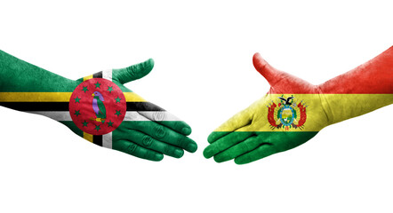 Handshake between Bolivia and Dominica flags painted on hands, isolated transparent image.