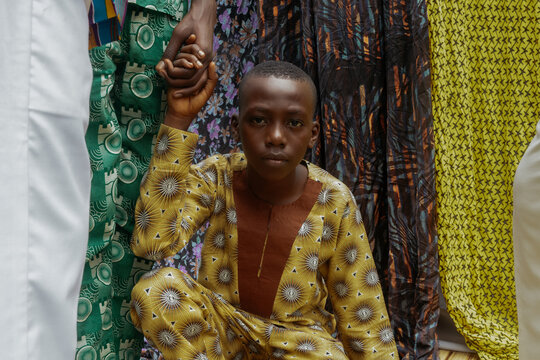 African child being held by elder brother