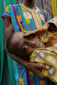 Nigerian Boy In Ankara Being Carried By Family 