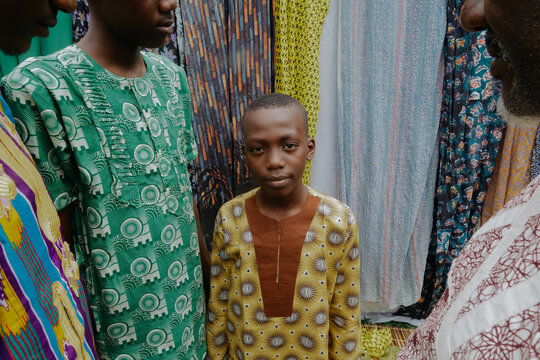Nigerian boy standing with family