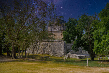 Fototapeta na wymiar Ruins of red house in Chichen Itza, Yucatan, Mexico, Maya civilization with Milky Way Galaxy stars night sky