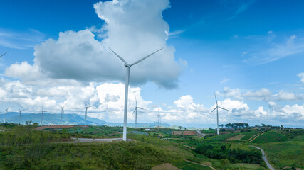 Fototapeta na wymiar Wind Turbines Windmill Energy Farm, Windmill on blue sky puffy clouds Alternative energy sources. Renewable electric sustainable nature energy technology. 