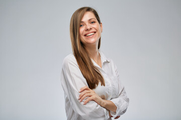 Isolated portrait of smiling business woman in white shirt standing with arms crossed.