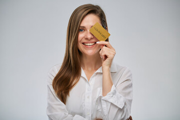 Smiling woman in white shirt holding credit card. Isolated advertising female portrait on white.