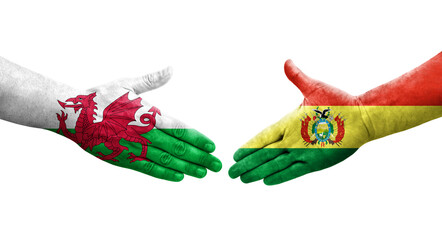 Handshake between Bolivia and Wales flags painted on hands, isolated transparent image.