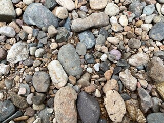 Light brown rock texture. Rough mountain surface. Close-up. Beige stone background with space for design. Web banner. Wide. Panoramic. Sandstone. Solid, rocky, slate.
