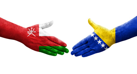 Handshake between Bosnia and Oman flags painted on hands, isolated transparent image.