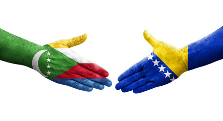 Handshake between Bosnia and Comoros flags painted on hands, isolated transparent image.