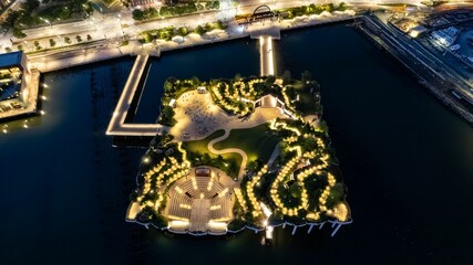 Aerial of the lights of Little Island public park in New York  captured at night on the Hudson river