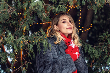 New Year's photos of a beautiful girl in the forest with a decorated Christmas tree, filled with...