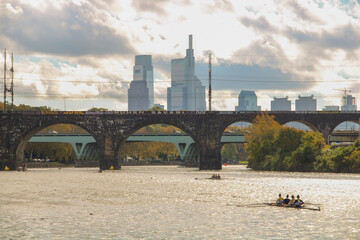 View of Schuylkill River with arch bridge and city buildings in the background. Philadelphia, USA.