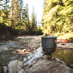 Cooking food using camping gas during the hike.
