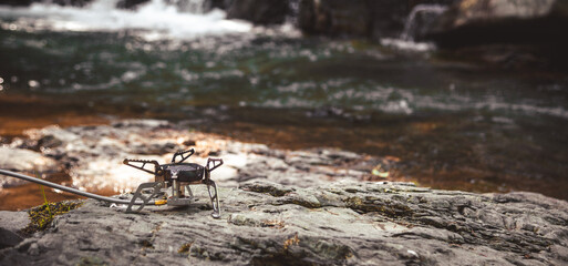 Cooking food using camping gas during the hike.